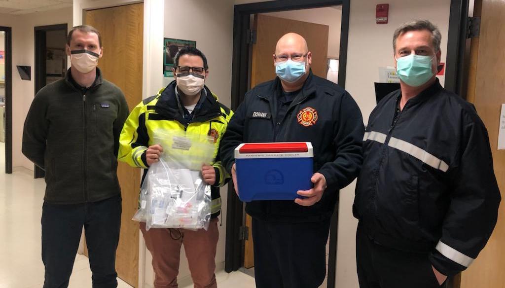 Kenosha Fire Department members pose with initial supply of COVID-19 vaccine