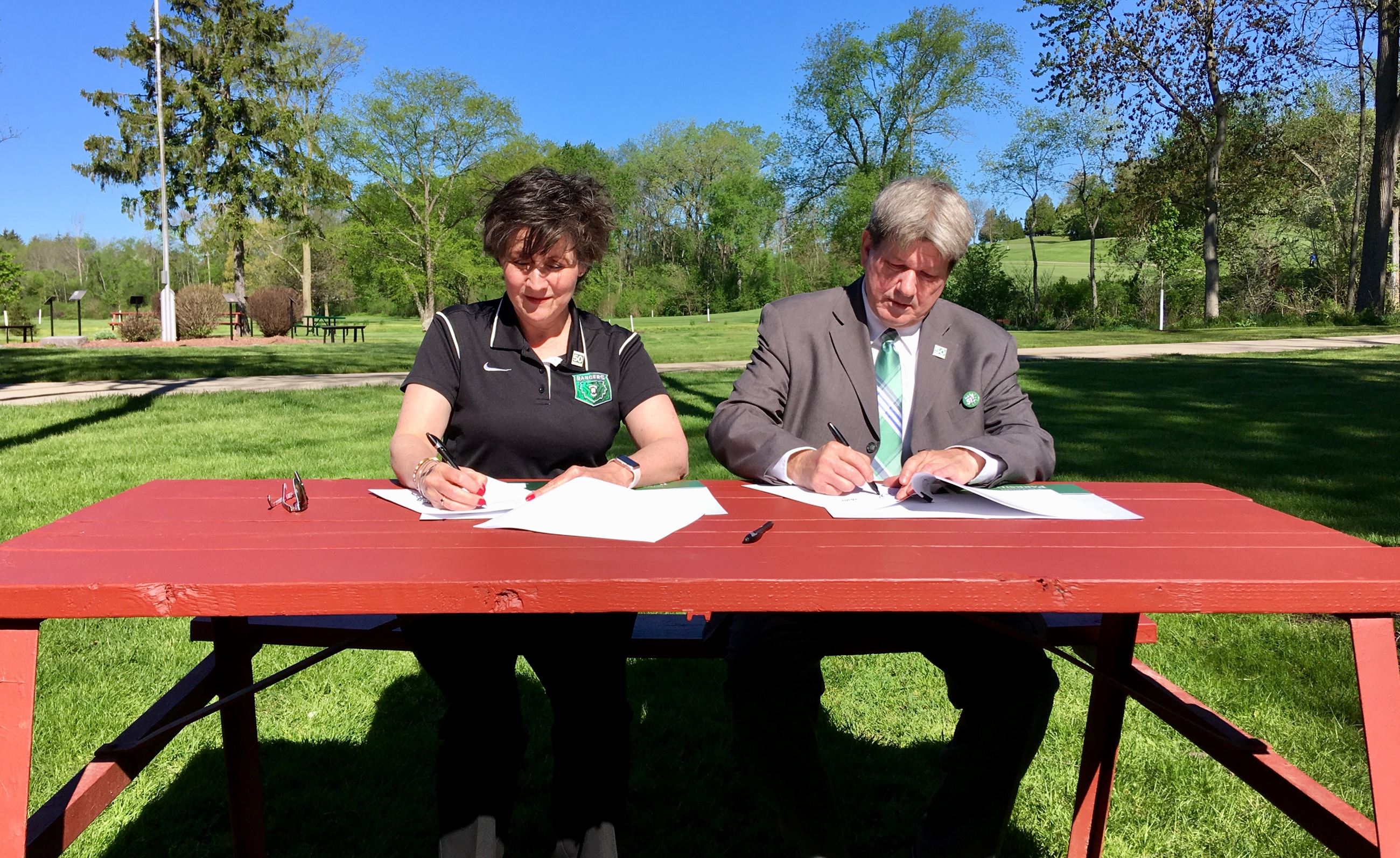 County Executive Jim Kreuser and UW-Parkside Chancellor Debbie Ford sign a collaborative land agreem